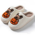 Black and white Halloween plush slippers with pumpkin design, round toe, and textured non-slip TPR soles.