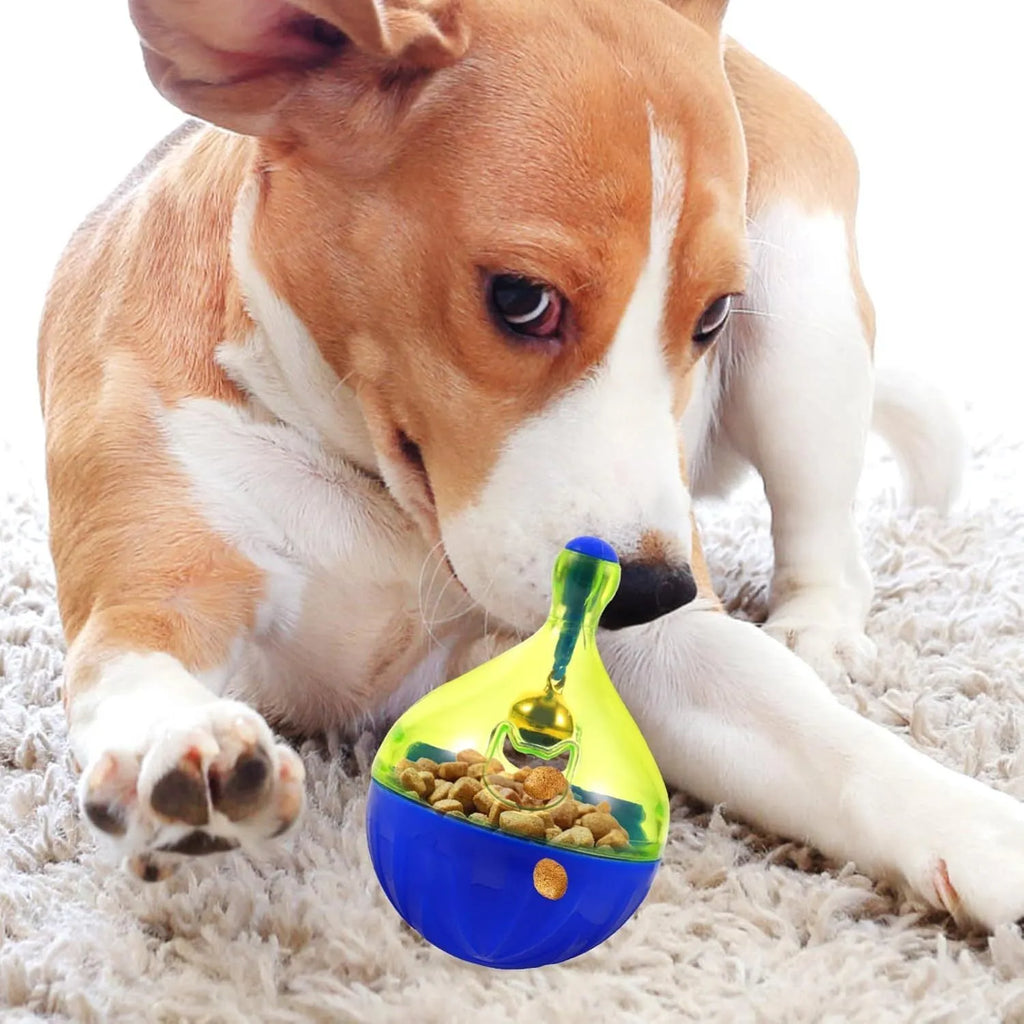 Blue and white tumbler-shaped interactive treat dispenser toy for dogs and cats on a wooden floor.