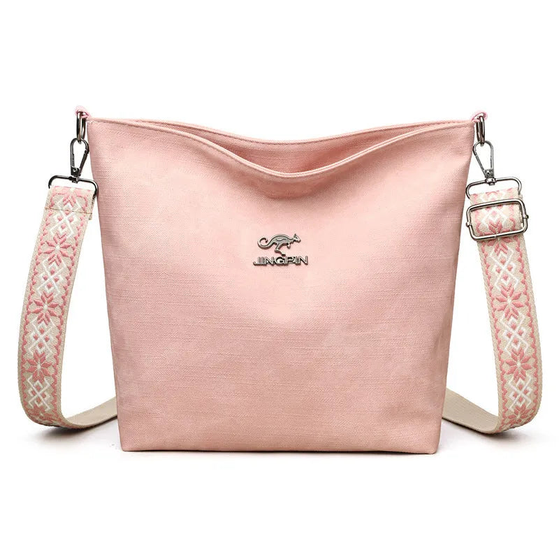 Soft PU leather women's crossbody bag in grey, pink, or yellow with an adjustable strap
