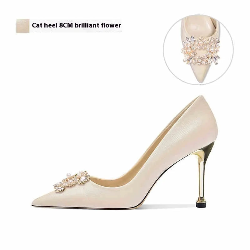 French crystal bridal high heel pumps with rhinestones on a cloth upper and pointed toe.