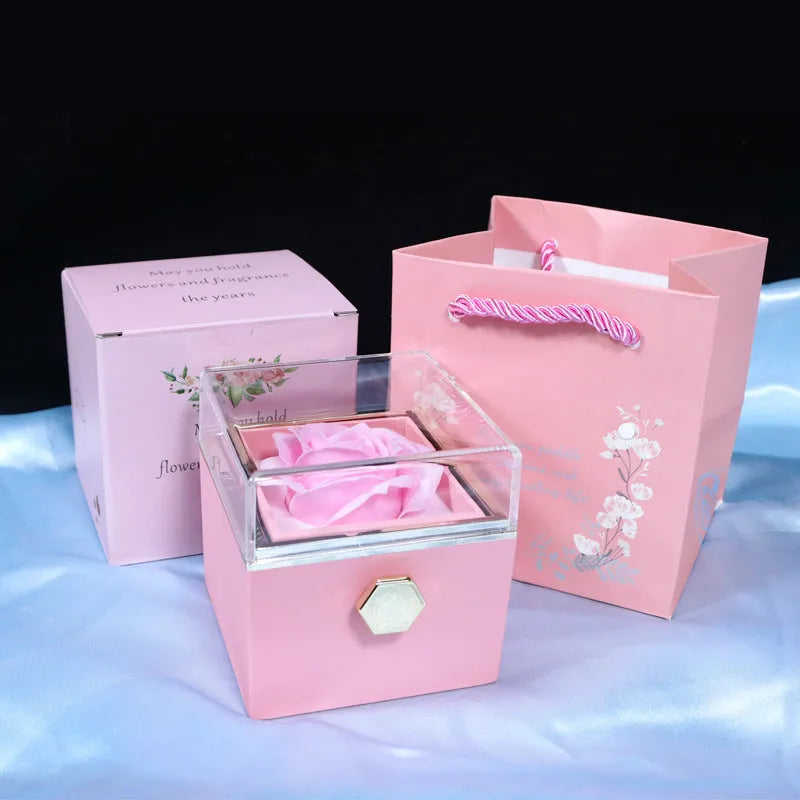 Rotating drawer jewellery gift box with preserved red rose under clear acrylic dome.