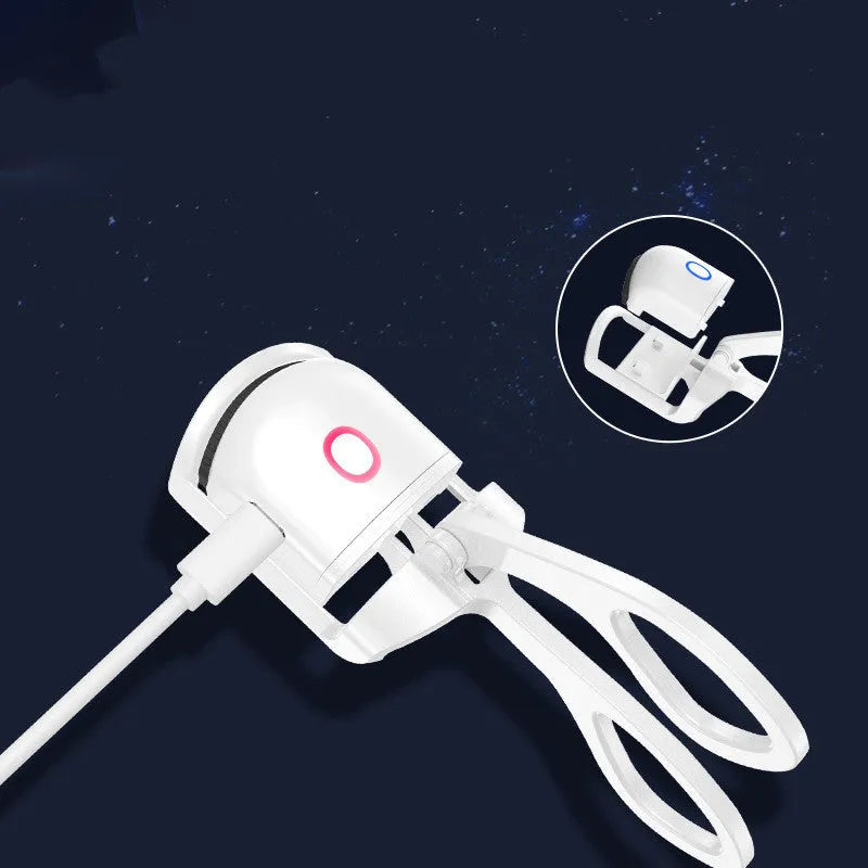 White and pink USB rechargeable heated eyelash curler with curved silicone pad.