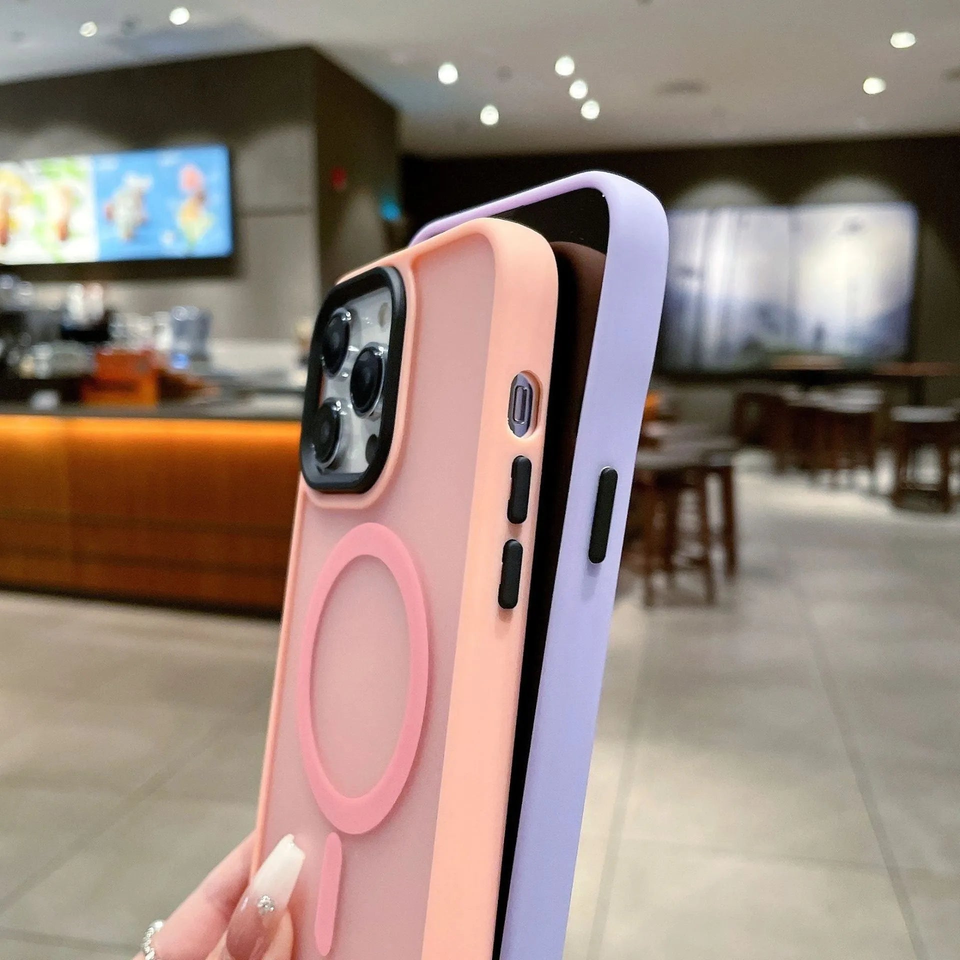 Frosted magnetic suction hard case for Apple iPhone 16 in dark purple colour on a table.