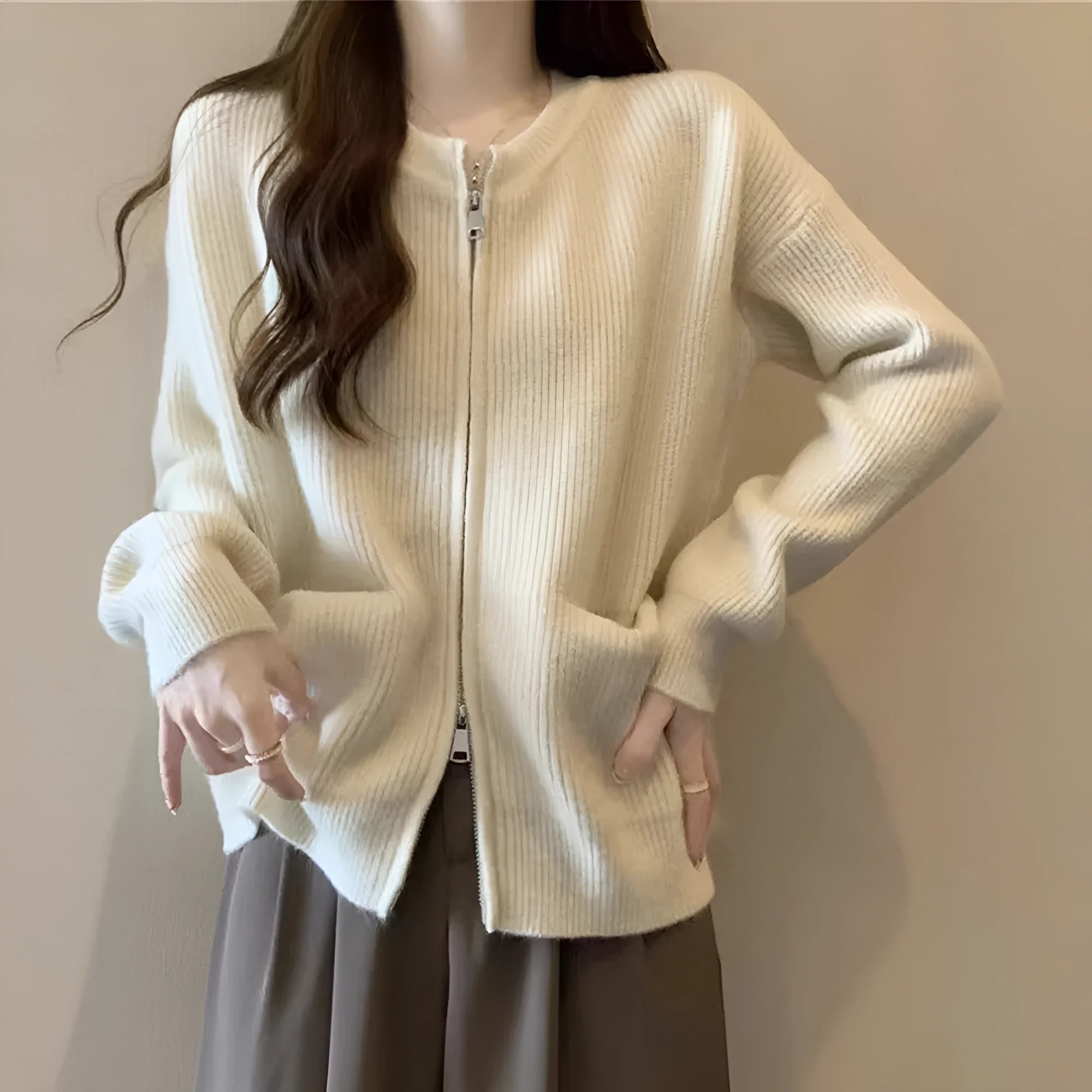 Beige women's long sleeve viscose cardigan sweater coat on a hanger