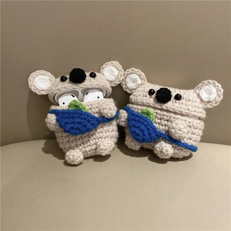 Handmade knitted koala bear backpack-shaped cover for an AirPods charging case.