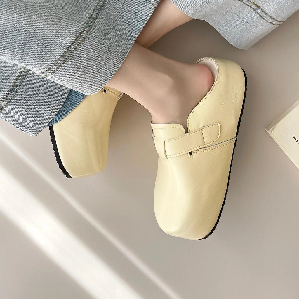 Flat buckle casual sneakers in yellow, creamy-white, silver, and black colours with round toe.