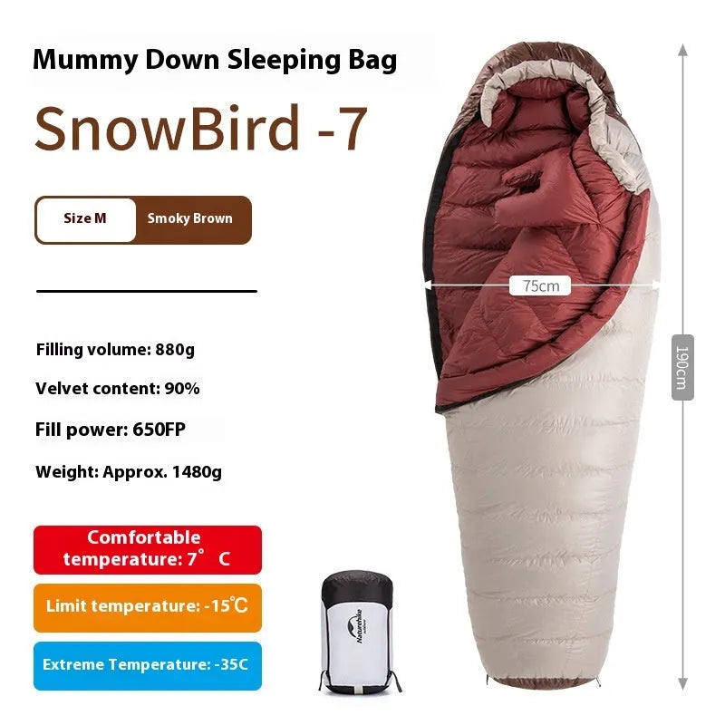Goose down mummy sleeping bag in a stuff sack, part of the snowbird range for camping.