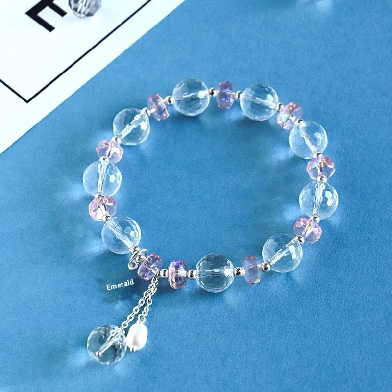 Women's white crystal bracelet with lucky cat charm and diamond-shaped stones on adjustable electroplated band