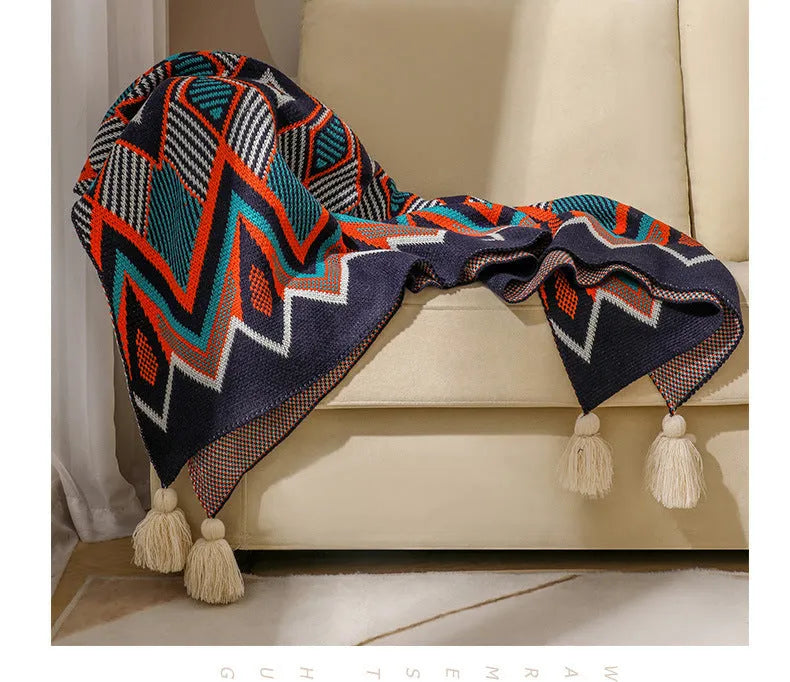 Bohemian style acrylic sofa cover blanket with tassel trim in a geometric pattern colour option.