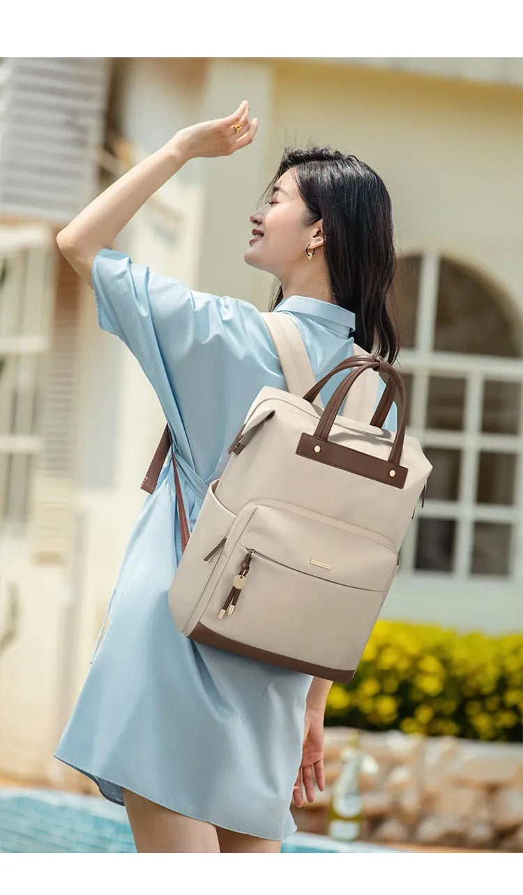 Women's large fabric backpack with synthetic leather trim in apricot colour, showing adjustable straps.