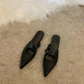 Women's soft leather-lined semi-toe box slippers with a rubber sole in dark brown.