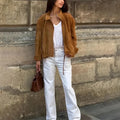 Retro solid colour loose-fit polyester jacket with long sleeves on a hanger.
