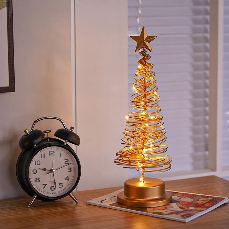 Wrought iron metal LED Christmas tree spiral light with warm white illumination on tabletop
