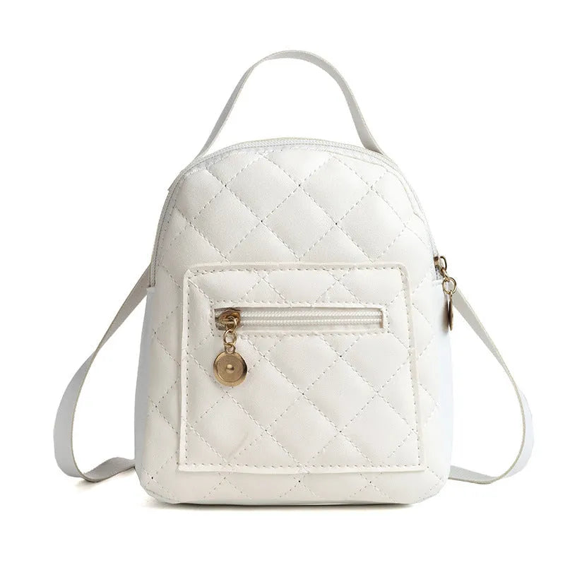A white hard-shell girls backpack with embroidery, showing its square shape and soft top handle.