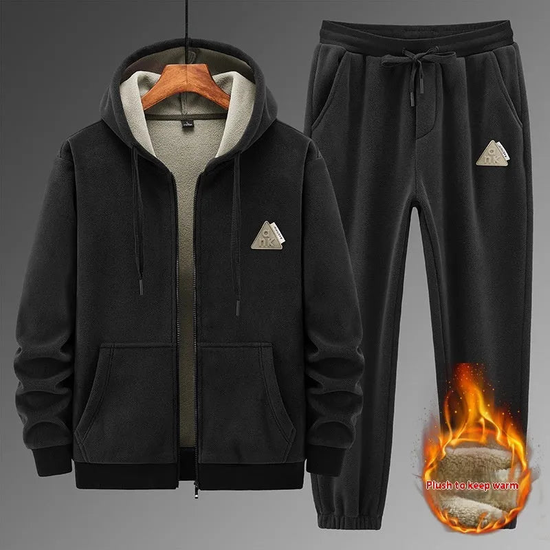 Grey hooded sweatshirt and matching trousers sports suit set laid flat