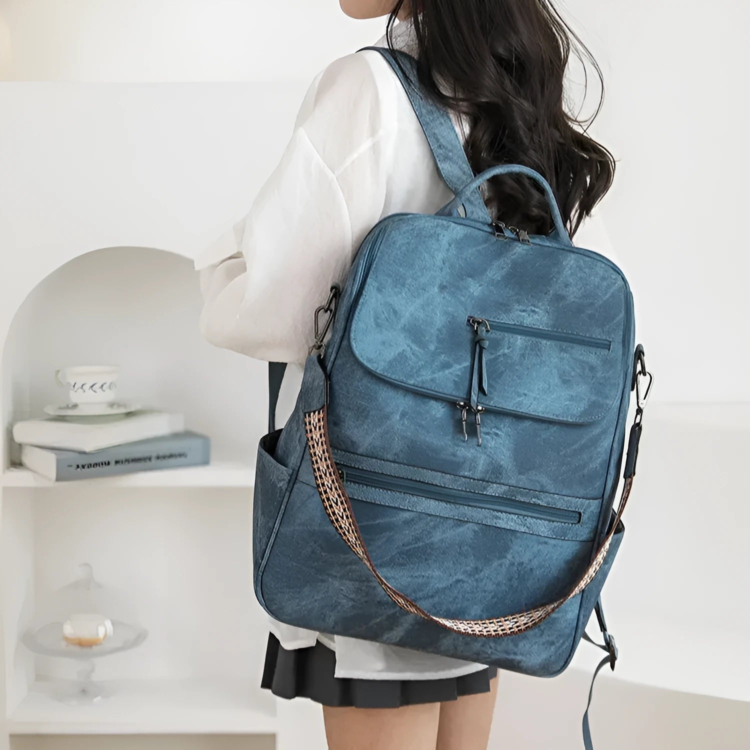 Retro college student backpack with curved shoulder straps in six colour options including black, blue and brown variations