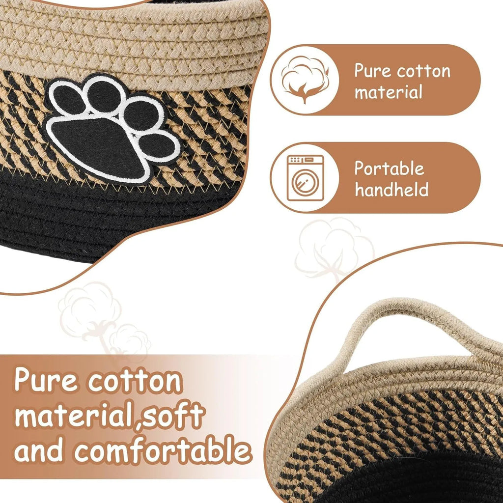 Light beige handmade woven cotton rope storage basket with a wooden handle on a wooden floor.