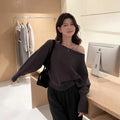 Women's long sleeve viscose pullover blouse in carbon grey, shown on a hanger.