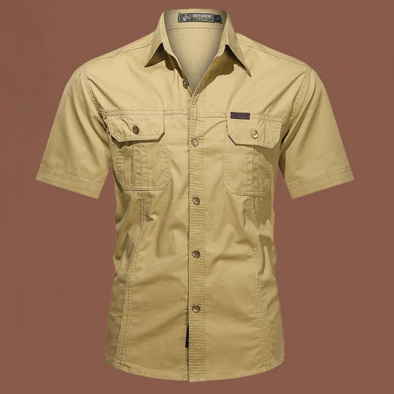 Man wearing a beige cotton short sleeve work shirt with a cardigan style and loose fit.