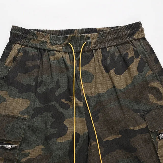 Men's green camouflage cotton work shorts with multiple pockets and a loose fit.