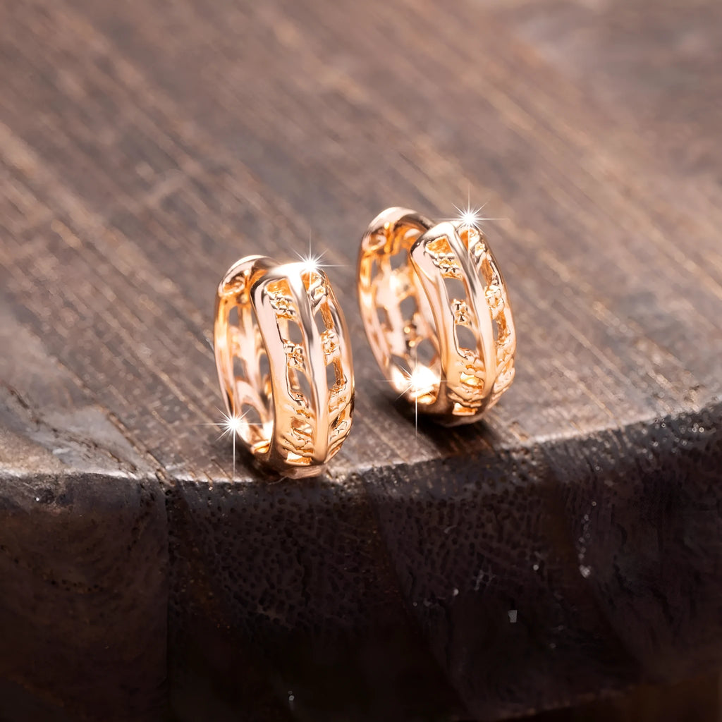 Rose gold plated copper earrings with hollowed-out heart and leaf shapes on a white background.