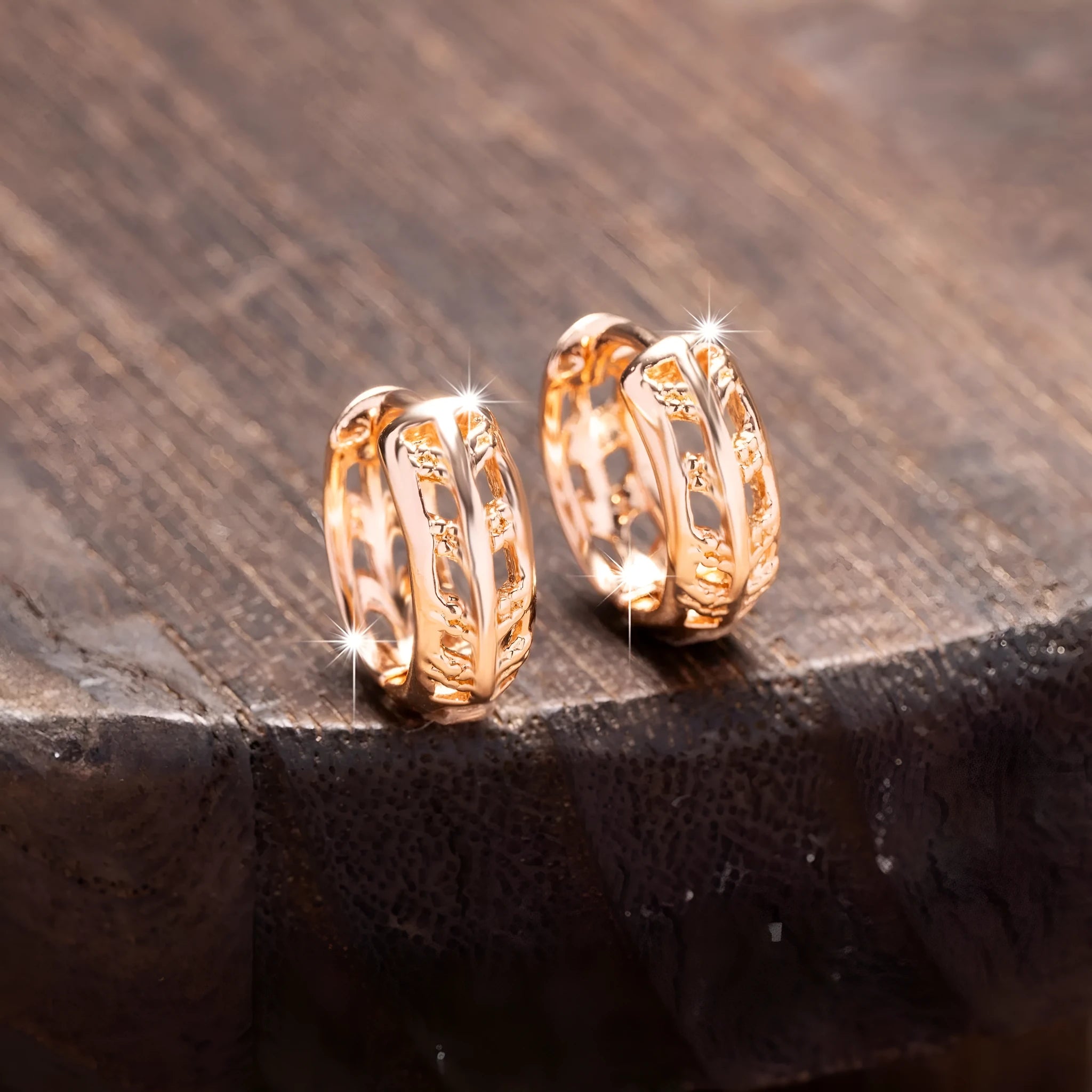 Rose gold plated copper earrings with hollowed-out heart and leaf shapes on a white background.