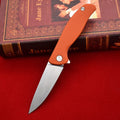 Outdoor folding knife with D2 steel blade, 9.6 cm blade length, 4.0 mm edge thickness, and nylon glass fibre handle in Black or Orange
