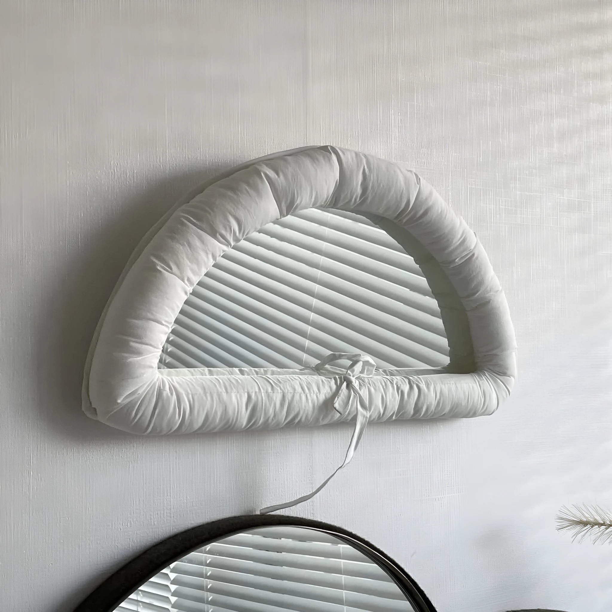 Soft cotton-filled hanging mirror in modern solid colour design