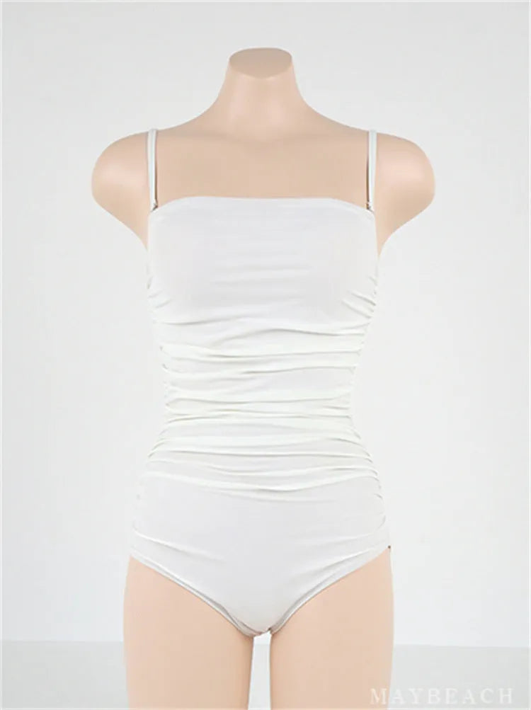 Sling style one-piece swimsuit with belly pleated detail in slim-fit silhouette