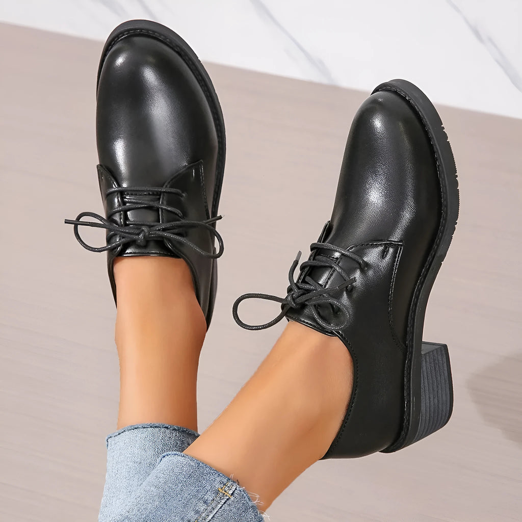 Black women's work shoes with thick rubber heel and soft sole, low top design with European styling