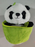 Black and white panda plush doll holding a simulated bamboo tube, a soft decorative cushion.
