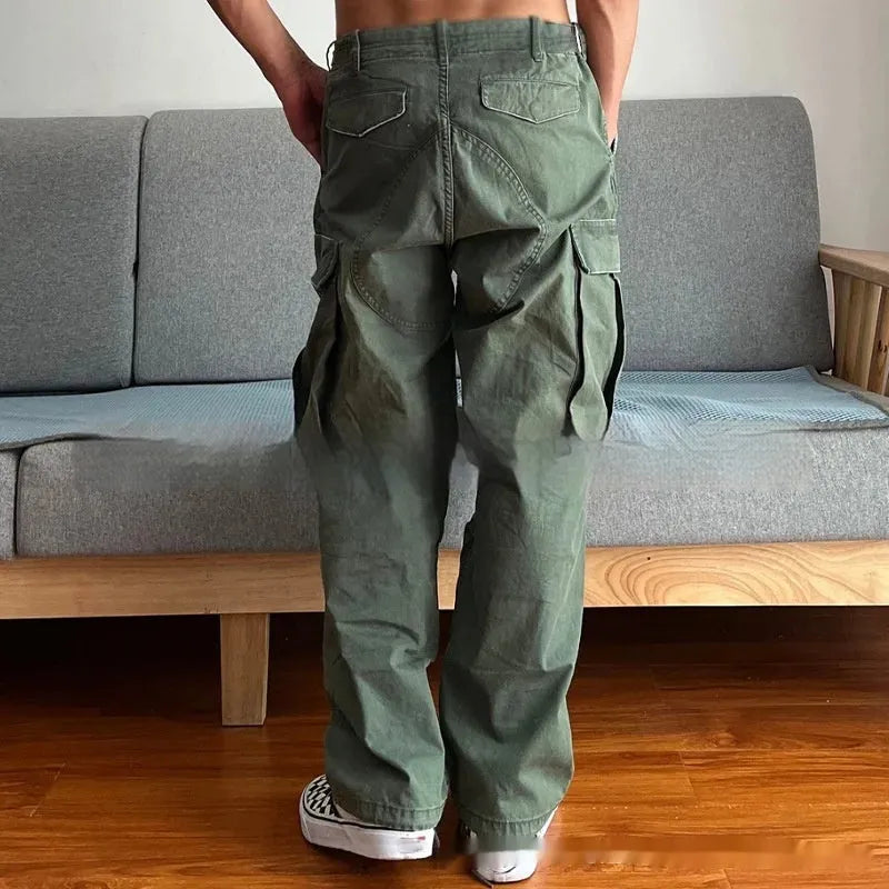 Men's loose fit washed cotton paratrooper pants in Army Green with large pockets, flat lay
