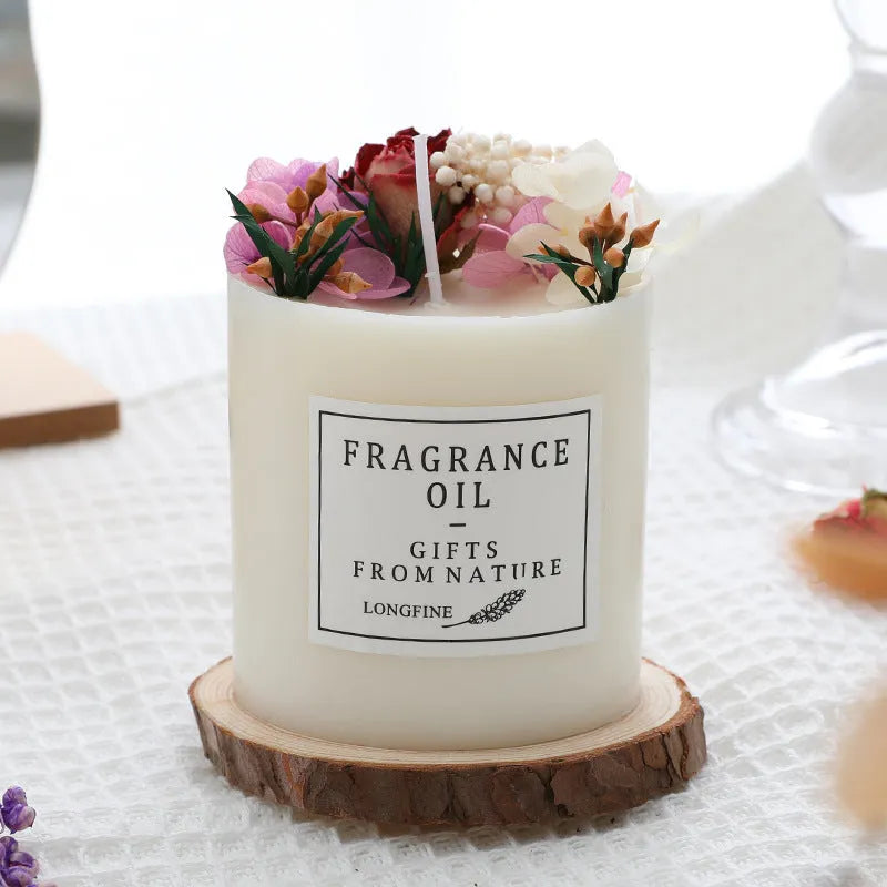 Decorative dried flower candle in jar with wooden chip base, available in nine botanical scents