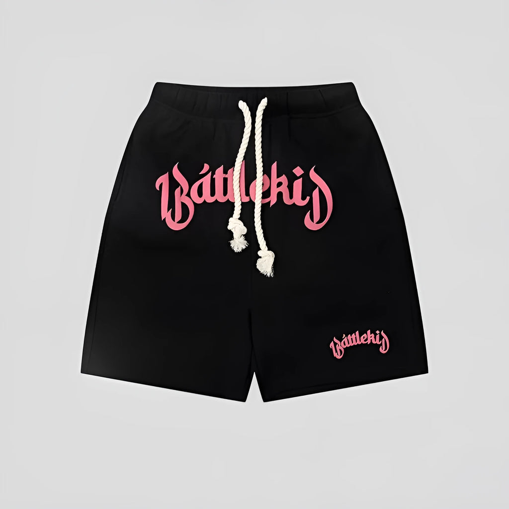Men's black cotton loose-fit street style cropped shorts on a grey background.