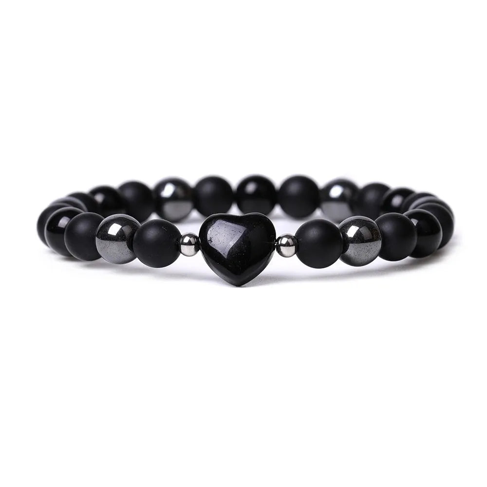 Hand-cut peach heart stone bracelet in geometric design with planetary elements