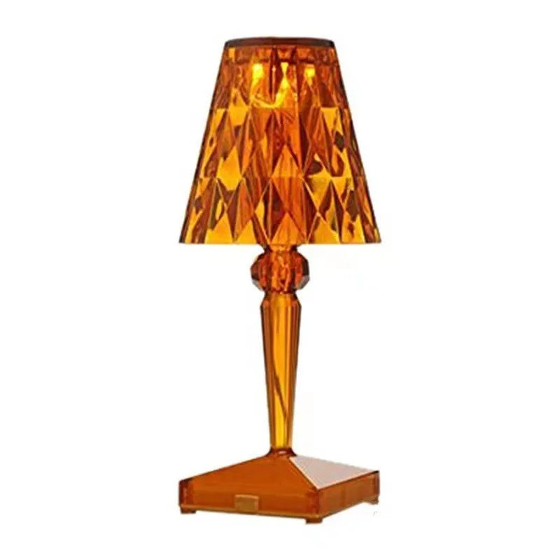 Rose gold portable touch night light on a surface showing its dimming touch controls.