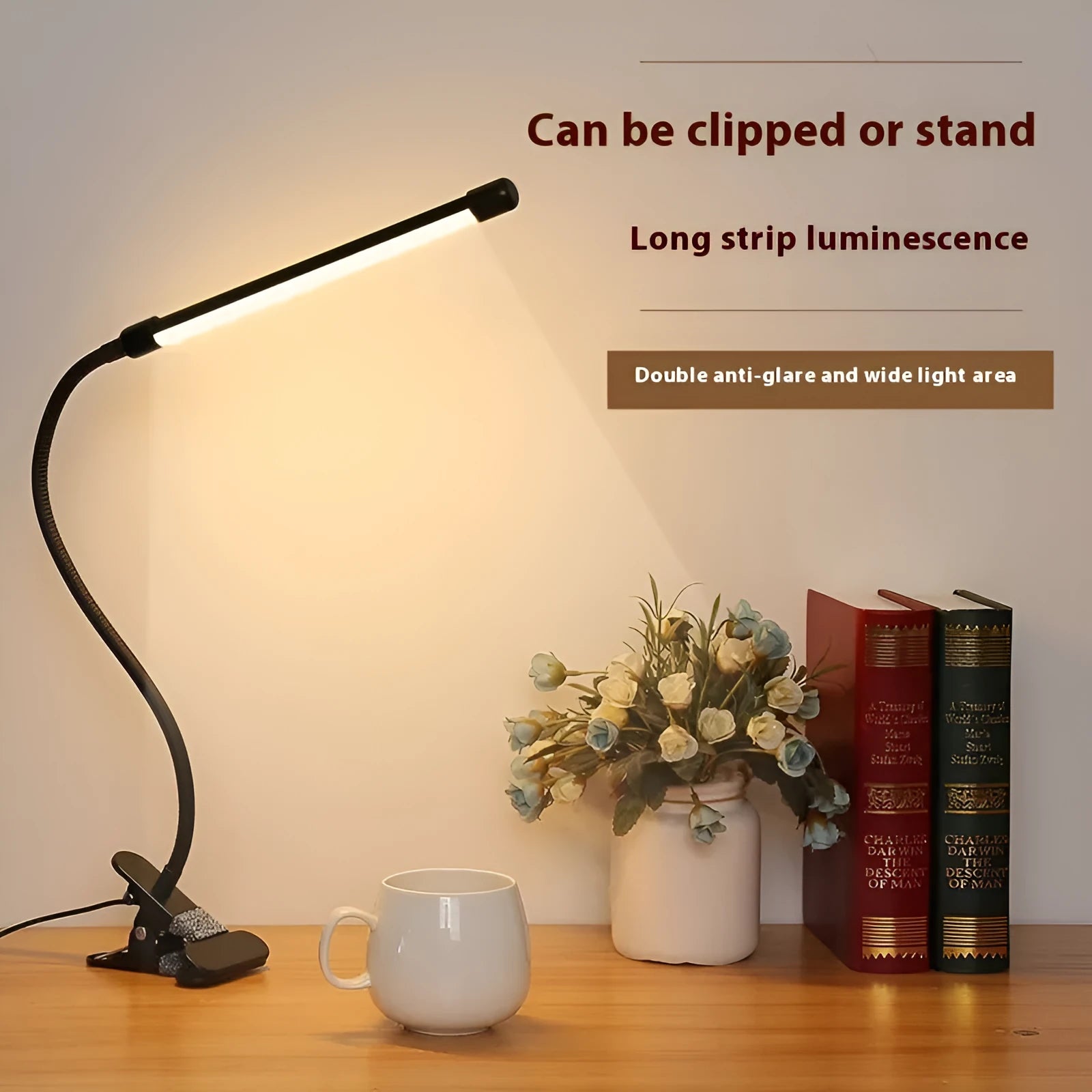 Black and white USB-powered LED desk lamp with a 26 cm long base on a wooden desk.