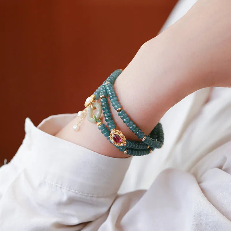 Women's blue water jade abacus beads bracelet with three tourmaline rings and pearl accents