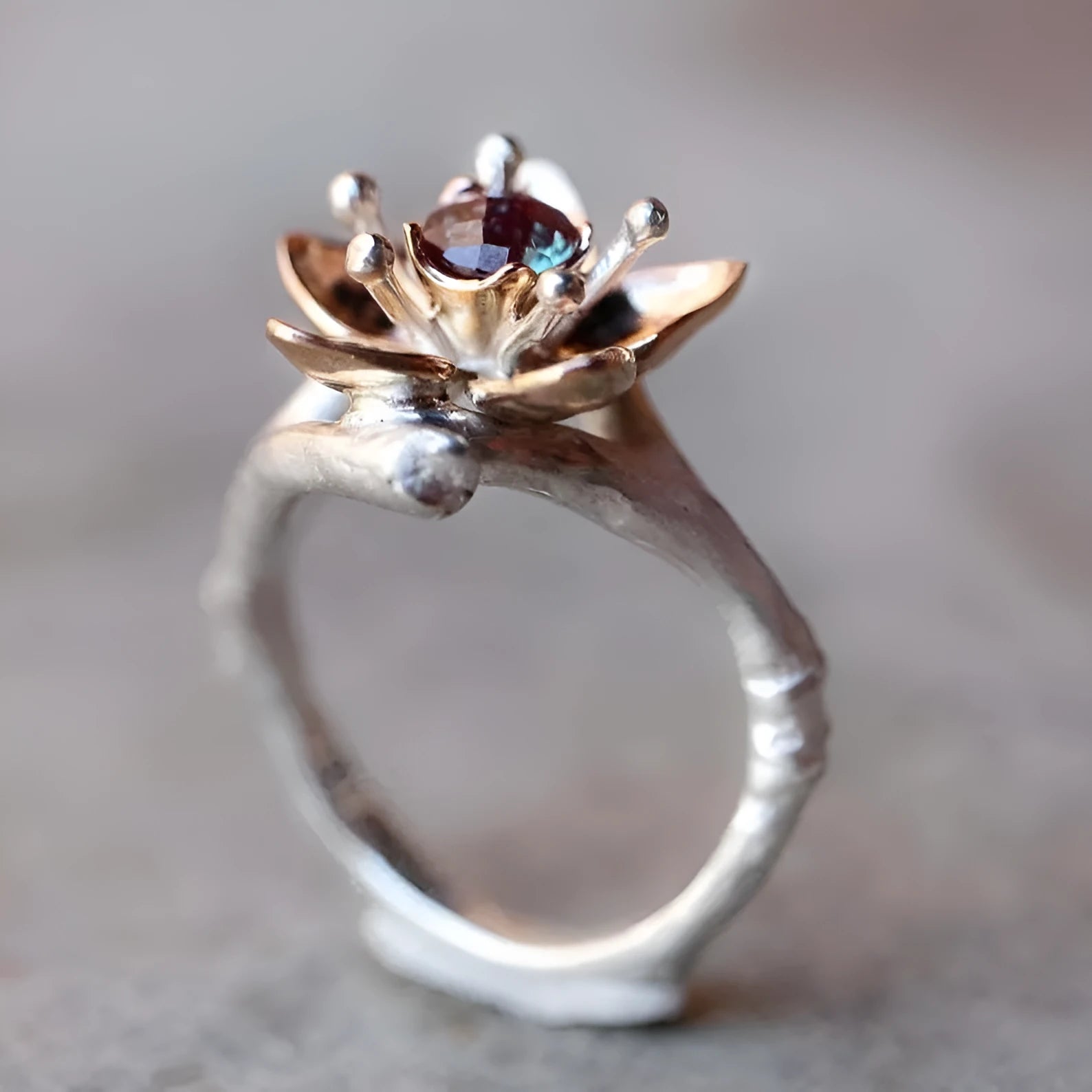 Silver two-tone alloy women's ring with geometric floral pattern on a finger.
