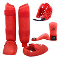 Red and blue karate protective gear set with helmet, boxing gloves and leg guards on training mat