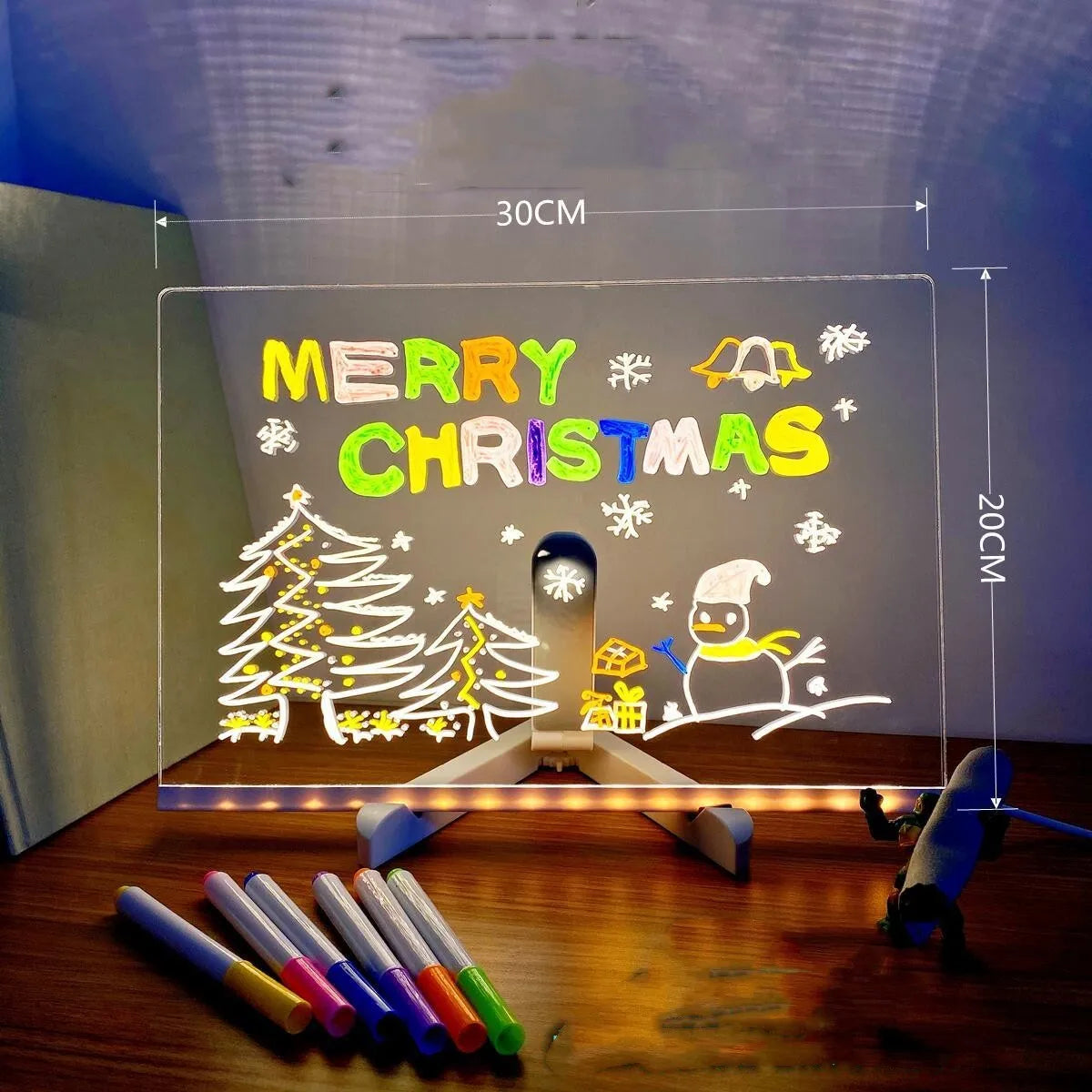 Acrylic LED message board night light on a desk with colourful handwritten notes glowing softly.