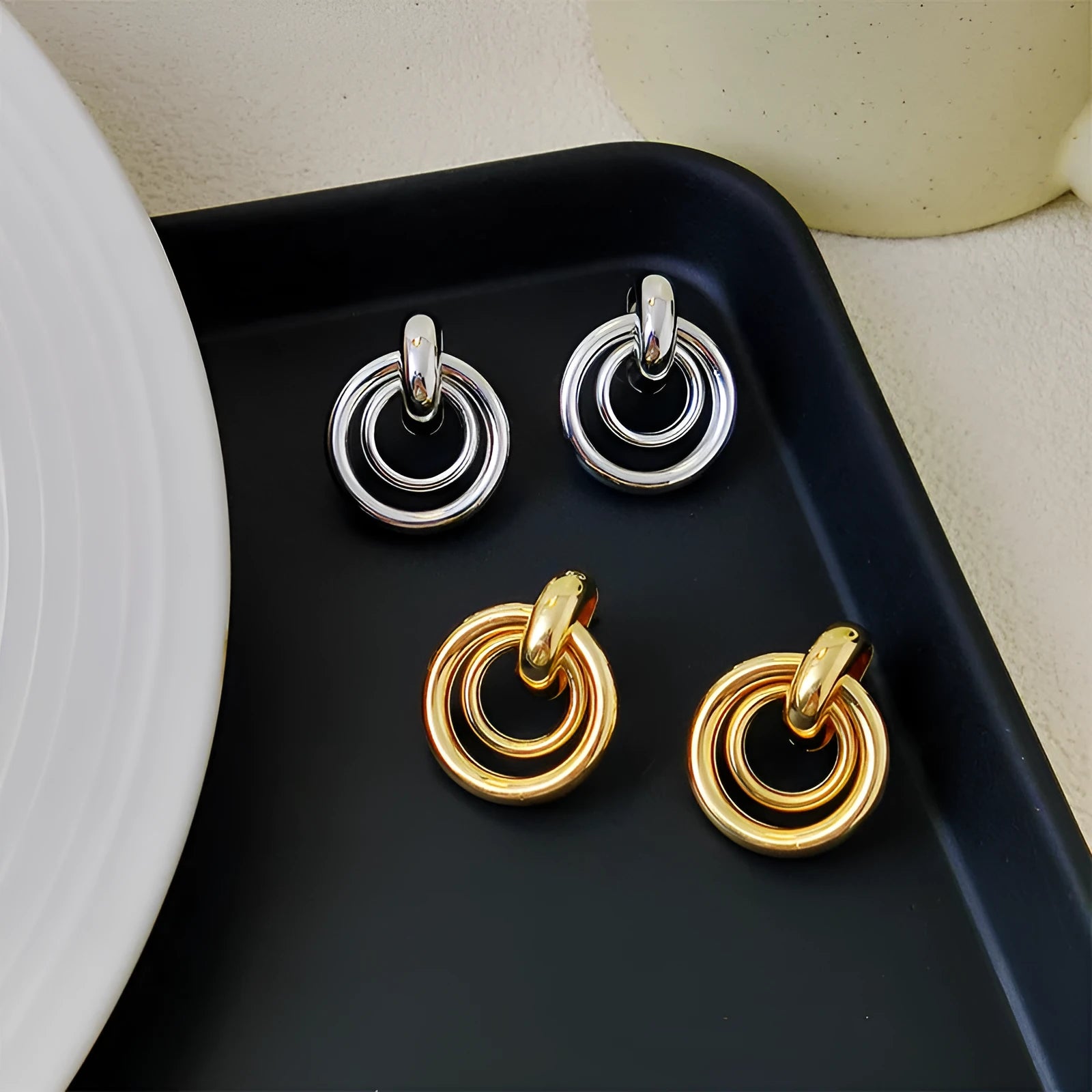 Geometric round ring earrings with irregular shape in gold electroplated finish on mixed material