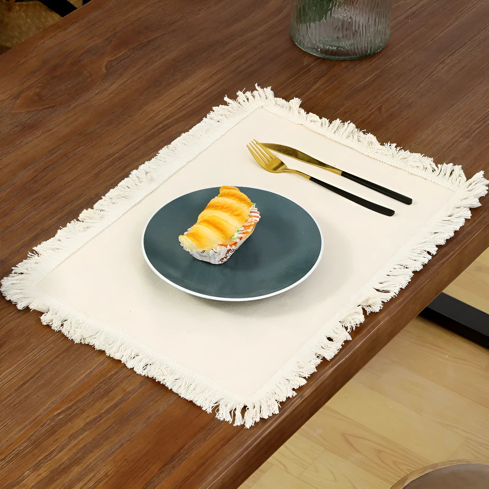 Solid colour square polyester placemat on table in beige colour
