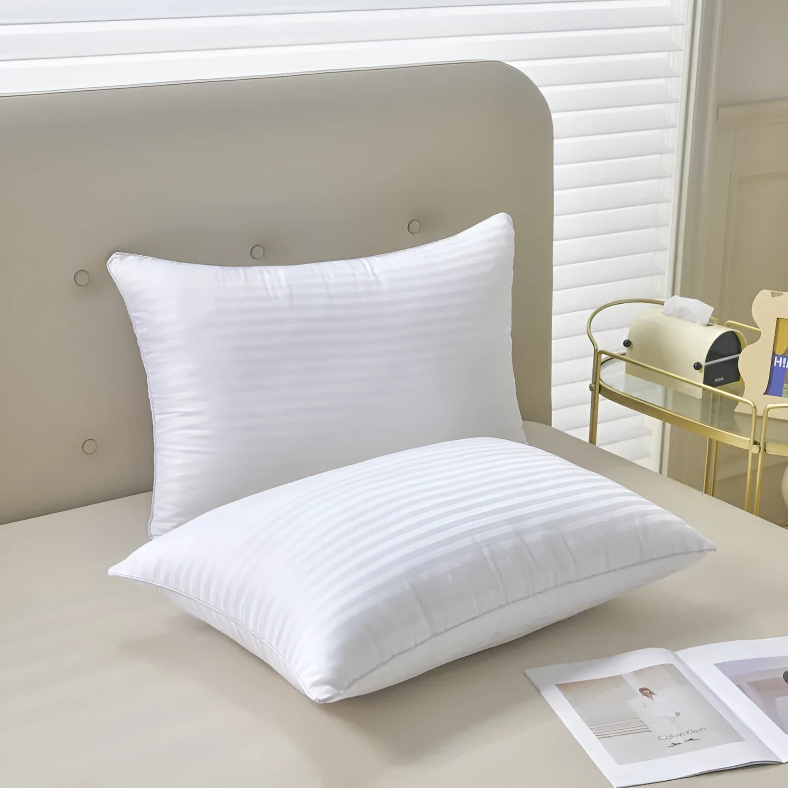 White cotton satin stripe feather pillow showing simple design and hotel-style aesthetic