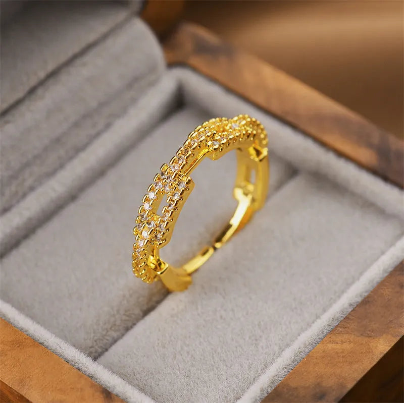 Gold geometric open adjustable ring made from copper with an electroplated finish.