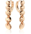A pair of long, round, woven copper earrings with a gold finish, showing textured detail.