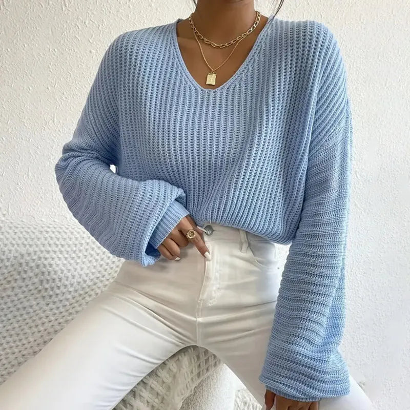 A woman wearing a solid colour long sleeve polyester pullover in a casual, loose fit.