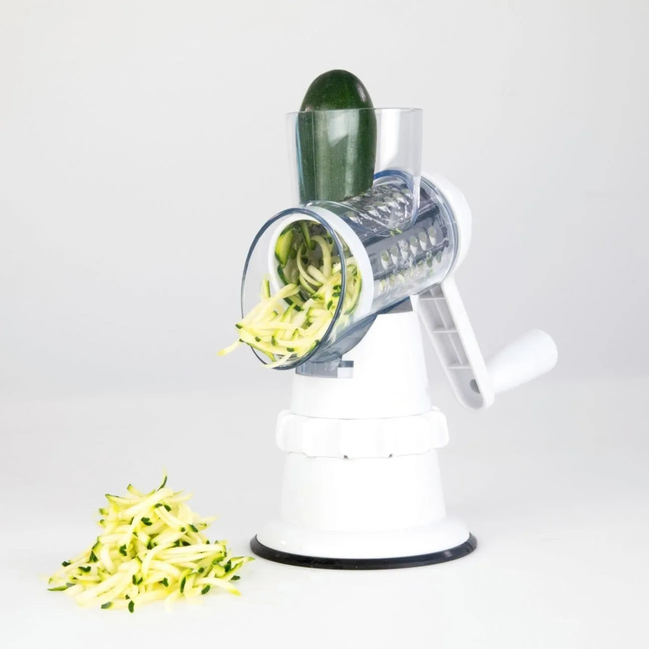White plastic manual vegetable slicer with rotating drum and suction feet