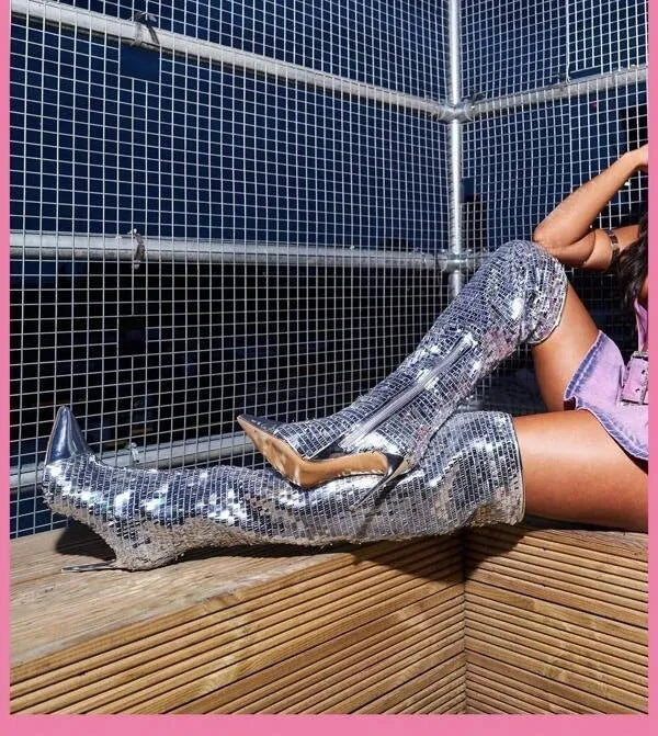 Women's black sequin over-the-knee boots with PU leather upper on display