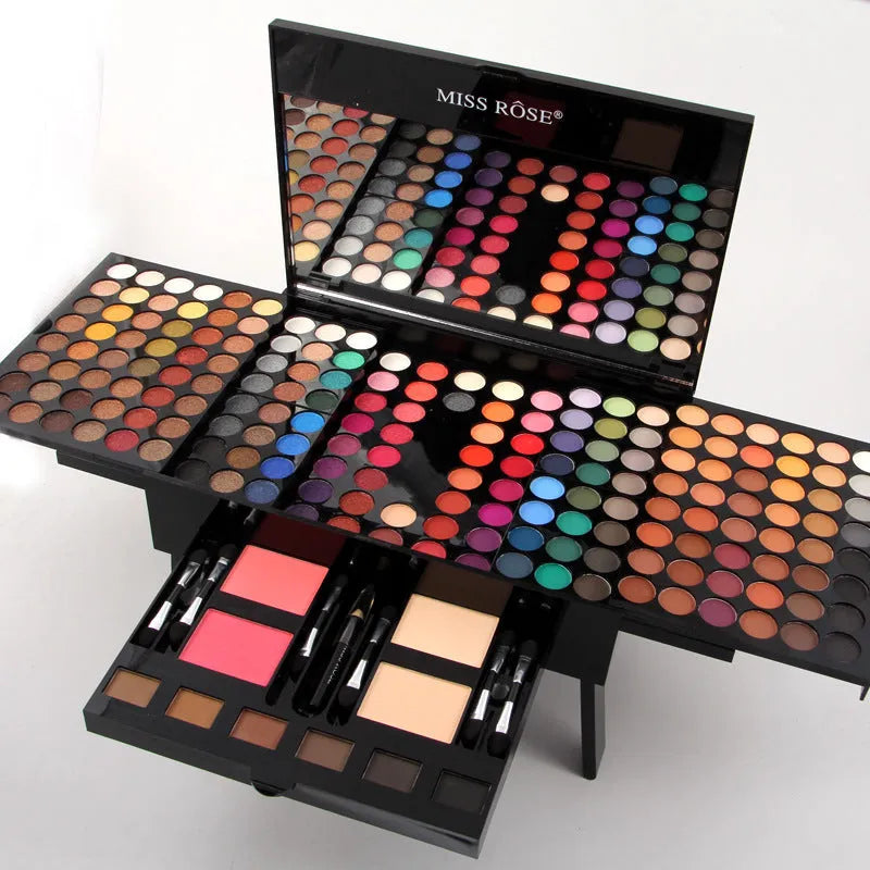 Piano-shaped open makeup palette showing 180 eyeshadows, blushers, and face powders